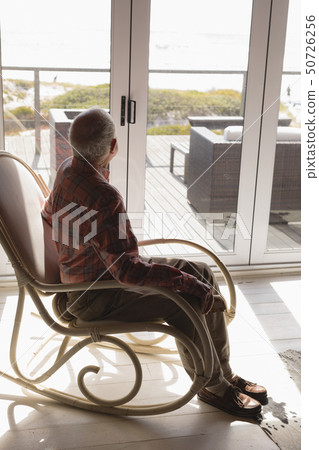 Senior man relaxing on rocking chair Senior man relaxing on rocking chair 50726256