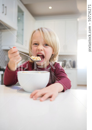 Boy having his breakfast at home 50726271
