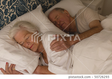 Senior couple sleeping together in bedroom Senior couple sleeping together in bedroom 50726293
