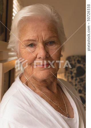 Happy senior woman relaxing in bedroom at home 50726338