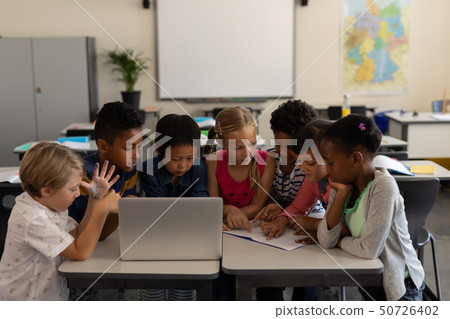 Group of school kids studying together in classroom Group of school kids studying together in classroom 50726402