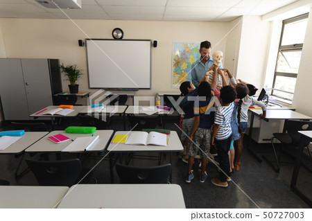 Far sight of schoolkids learning anatomy of human skeleton in classroom Far sight of schoolkids learning anatomy of human skeleton in classroom 50727003