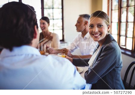 Businesswoman looking at camera in restaurant Businesswoman looking at camera in restaurant 50727290