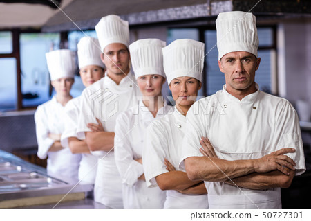 Group of chefs standing in kitchen Group of chefs standing in kitchen 50727301