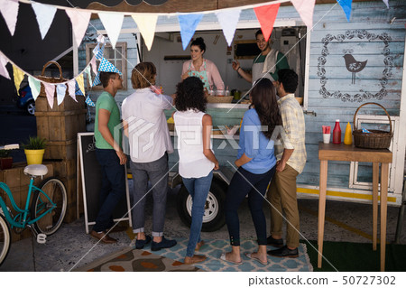 Smiling waitress taking order from customer Smiling waitress taking order from customer 50727302