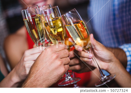 Friends toasting champagne glass in nightclub Friends toasting champagne glass in nightclub 50727324
