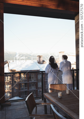 Couple looking at view from balcony Couple looking at view from balcony 50727570