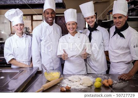 Female chef preparing food in kitchen Female chef preparing food in kitchen 50727729