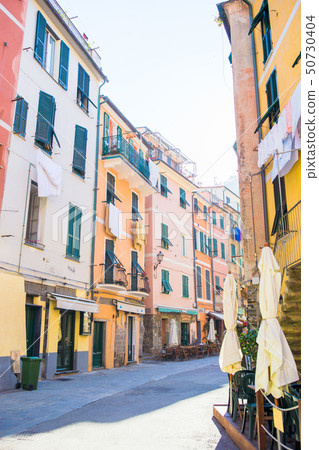 Old beautiful empty narrow streets with outdoor cafe in coastal village in Cinque Terre, Italy 50730404