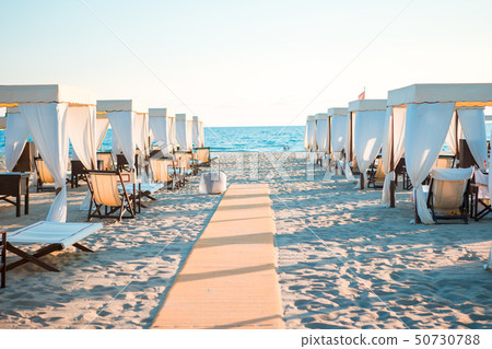 Sunbeds in famous italian sand beach at Forte dei Marmi Sunbeds in famous italian sand beach at Forte dei Marmi 50730788
