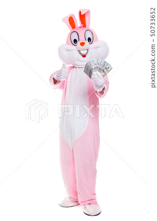 Easter bunny rabbit with fan of dollars, celebrates easter. Rich lucky man holds money hundred 50733652