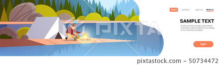 woman hiker making fire near tent camp african girl holding firewood for bonfire hiking camping 50734472