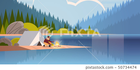 woman hiker making fire near tent camp african american girl holding firewood for bonfire hiking 50734474