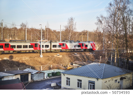 electric train leaves the autumn forest in the electric train leaves the autumn forest in the 50734593