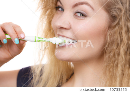 Woman brushing cleaning teeth Woman brushing cleaning teeth 50735353