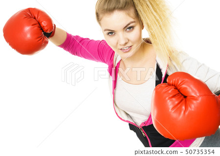 Woman wearing boxing gloves Woman wearing boxing gloves 50735354