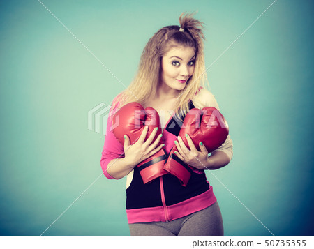 Funny girl in red gloves playing sports boxing Funny girl in red gloves playing sports boxing 50735355
