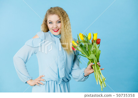 Pretty woman with red yellow tulips bunch Pretty woman with red yellow tulips bunch 50735358