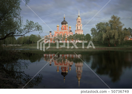 Resurrection Cathedral in Staraya Russa is reflected in the river. Spring landscape. 50736749