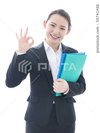Smiling business woman holding a file making an ok sign Smiling business woman holding a file making an ok sign 50741488
