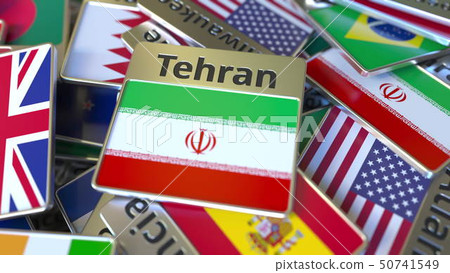 Souvenir magnet or badge with Tehran text and national flag among different ones. Traveling to Iran 50741549