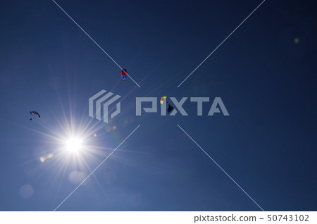 Paraglider flies paraglider in the sky. Paragliding. 50743102