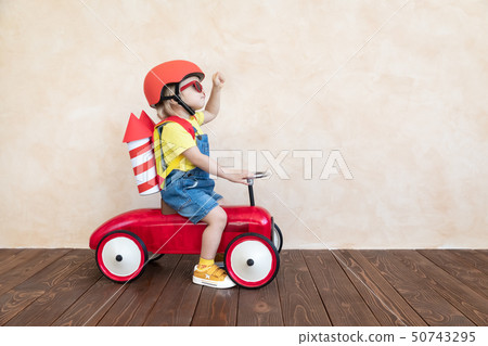 Kid playing with toy rocket at home Kid playing with toy rocket at home 50743295