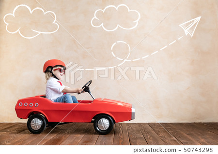 Funny kid driving toy car at home 50743298
