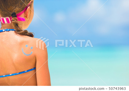 Close up smile painted by sun cream on kid shoulder 50743963