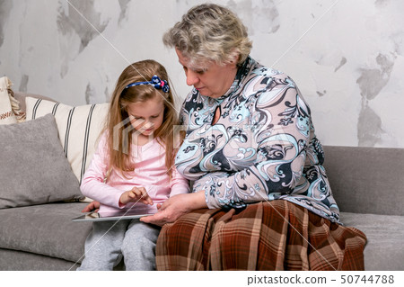 Grandmother and her little granddaughter 50744788