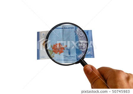 one Malaysia Ringgit bill and magnifying glass in 50745983
