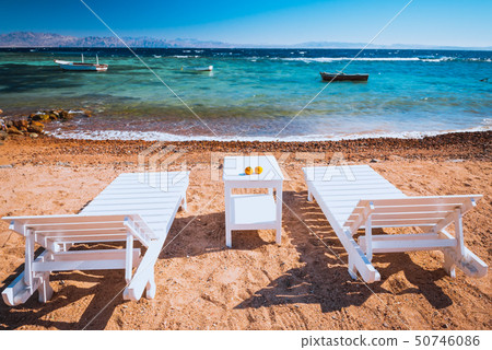 lounge chairs on beautiful tropical beach at Egypt 50746086
