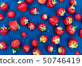 red strawberry on a blue napkin, food background, 50746419