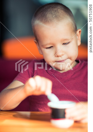 Portrait of a boy eating ice cream 50751908
