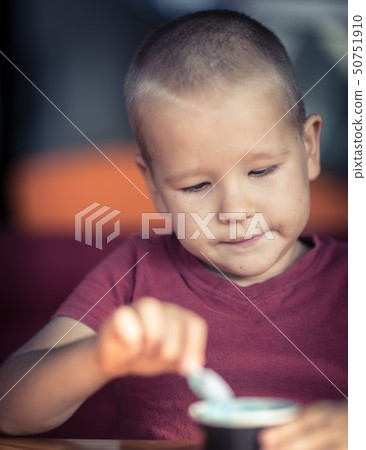 Portrait of a boy eating ice cream Portrait of a boy eating ice cream 50751910