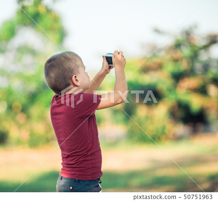Little cute boy with camera 50751963
