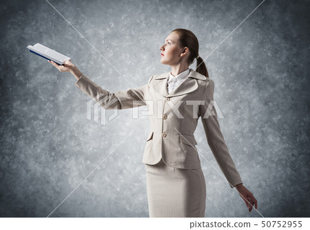 Attractive woman holding open notebook Attractive woman holding open notebook 50752955