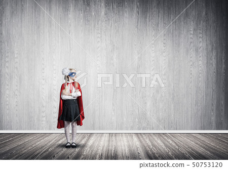 Girl power concept with cute kid guardian in empty room. Mixed media Girl power concept with cute kid guardian in empty room. Mixed media 50753120