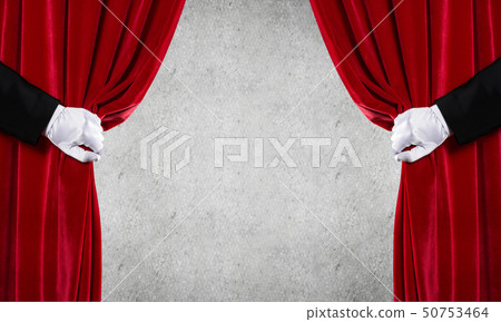 Concrete wall behind drapery curtain and hand opening it Concrete wall behind drapery curtain and hand opening it 50753464