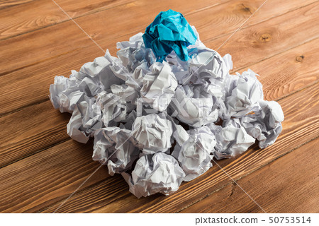 Concept of creativity and inspiration presented by many white paperballs and one color Concept of creativity and inspiration presented by many white paperballs and one color 50753514