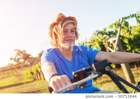 Young farmer riding quad bike Young farmer riding quad bike 50753844