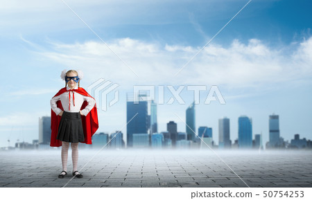 Girl power concept with cute kid guardian against cityscape background . Mixed media Girl power concept with cute kid guardian against cityscape background . Mixed media 50754253
