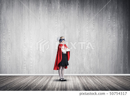 Girl power concept with cute kid guardian in empty room. Mixed media Girl power concept with cute kid guardian in empty room. Mixed media 50754317