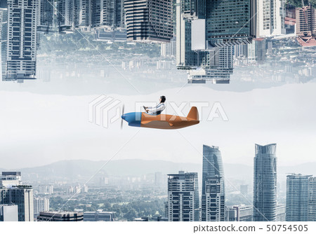 Aircraft pilot in leather helmet sitting in cabin 50754505