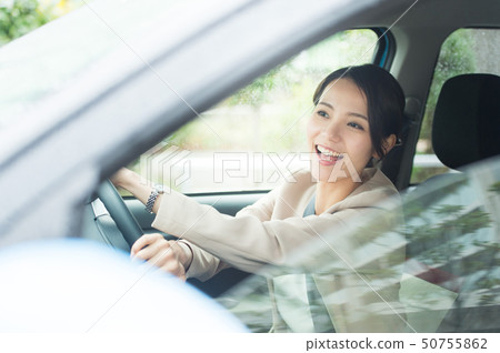 A woman driving a car A woman driving a car 50755862
