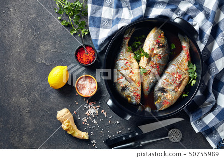 Raw dorado fishies marinated with spices, flatlay Raw dorado fishies marinated with spices, flatlay 50755989