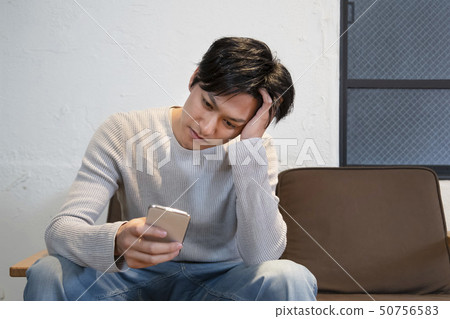 Man thinking smart phone in hand Man thinking smart phone in hand 50756583