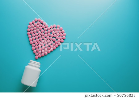 Pink B12 pills in the shape of a heart on a blue Pink B12 pills in the shape of a heart on a blue 50756825