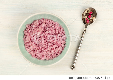 A bowl of pink Himalayan sea salt with a pepper mix, shot from the top on a white wooden background A bowl of pink Himalayan sea salt with a pepper mix, shot from the top on a white wooden background 50759148