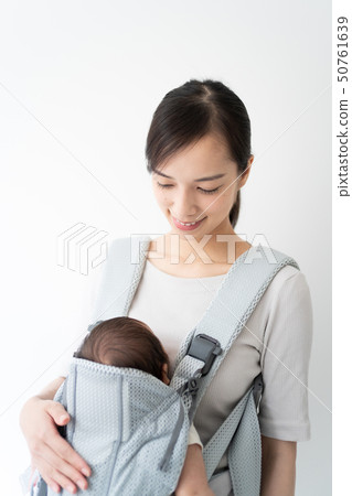 A woman who causes a baby to drink milk A woman who causes a baby to drink milk 50761639